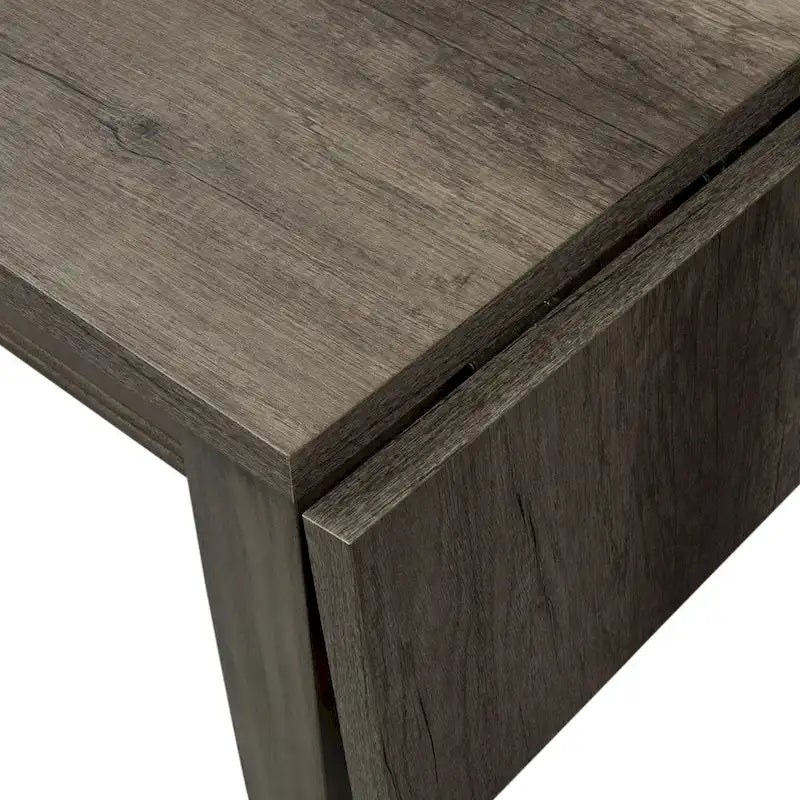 Mesa de comedor gris con alas abatibles, capacidad 2–4 personas